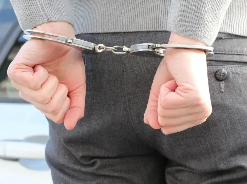 Closeup of a man's hands, handcuffed behind his back